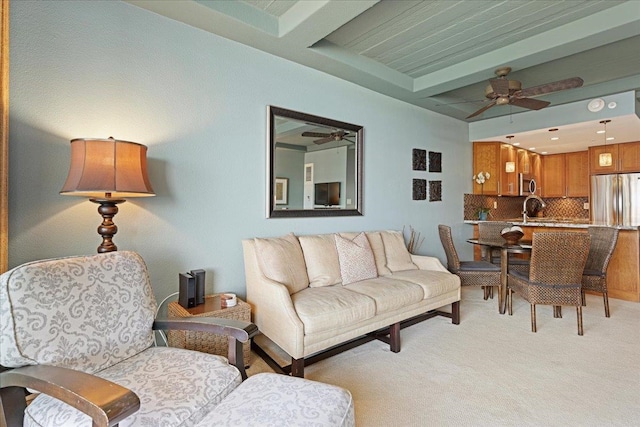 carpeted living room with sink