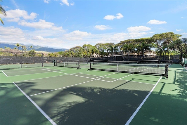 view of tennis court with a mountain view