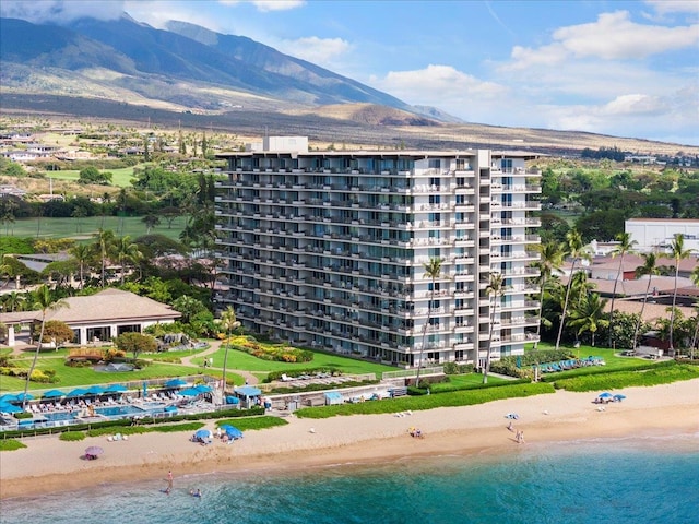 exterior space with a water and mountain view and a view of the beach