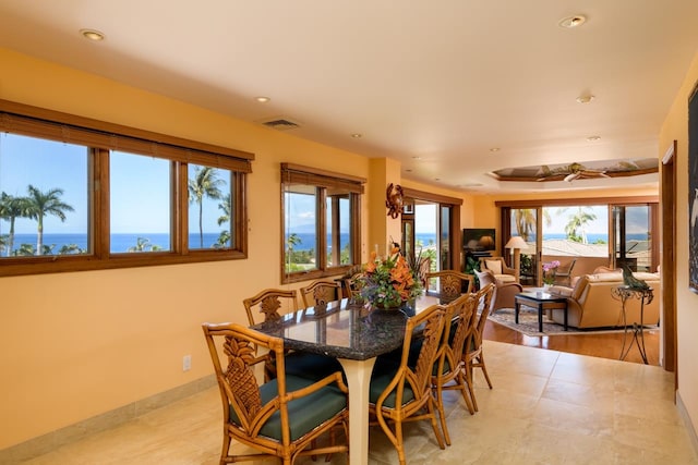 tiled dining space with a water view