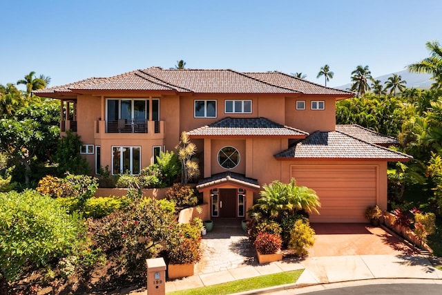 mediterranean / spanish house featuring a garage