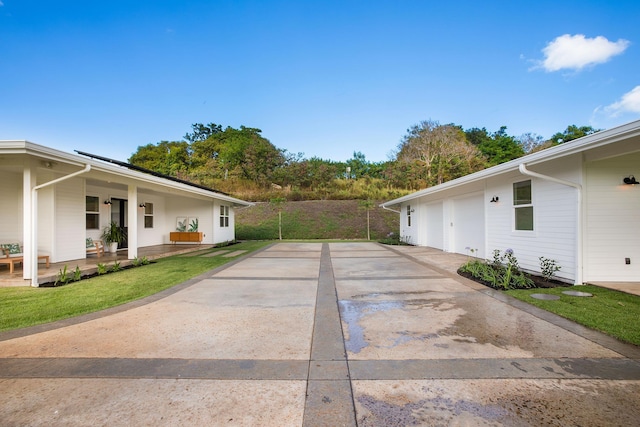 view of side of property featuring a porch and a garage