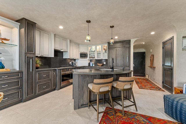 12 S Kihei Rd Unit E2, Kihei, HI 96753 - kitchen with appliances with stainless steel finishes, dark countertops, light tile patterned flooring, recessed lighting, and hanging light fixtures