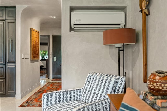 12 S Kihei Rd Unit E2, Kihei, HI 96753 - living area with a wall mounted air conditioner and light tile patterned flooring