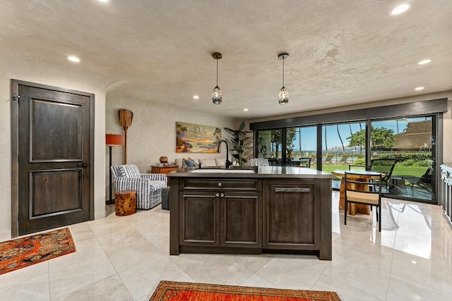 12 S Kihei Rd Unit E2, Kihei, HI 96753 - kitchen featuring recessed lighting, dark brown cabinets, hanging light fixtures, a kitchen island with sink, and light tile patterned floors