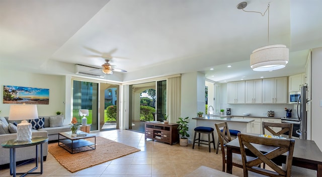 tiled living room with sink, a wall mounted AC, and ceiling fan