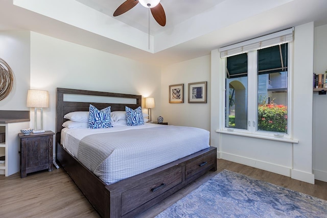 bedroom with ceiling fan and light hardwood / wood-style floors