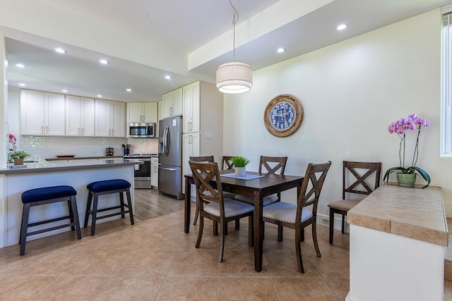 dining space featuring light tile patterned floors