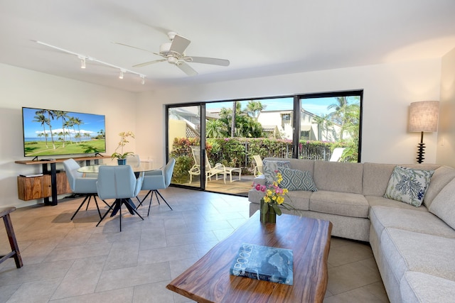 living room with light tile patterned floors, track lighting, ceiling fan, and plenty of natural light