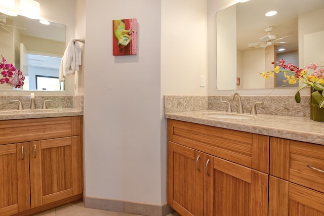 bathroom with tile patterned flooring, vanity, and ceiling fan