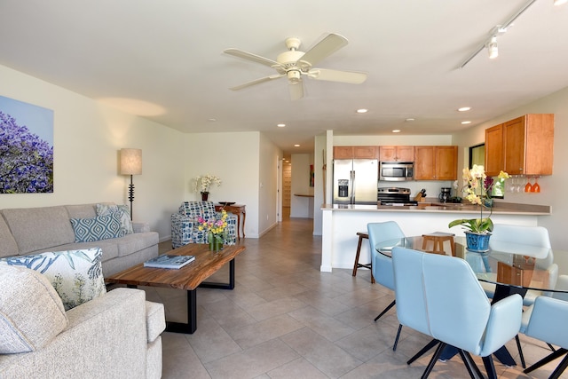 living room featuring ceiling fan and track lighting