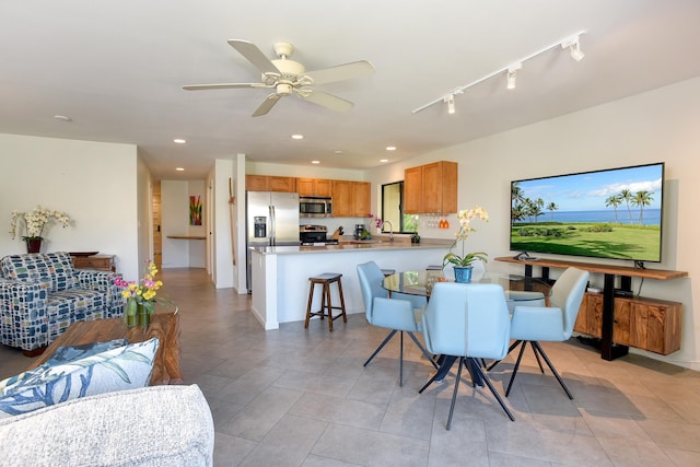 dining room featuring rail lighting, light tile patterned floors, and ceiling fan