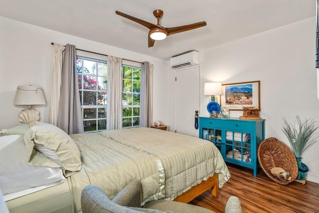 bedroom featuring a wall mounted air conditioner, wood-type flooring, and ceiling fan