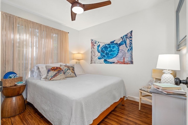 bedroom with ceiling fan and dark hardwood / wood-style floors