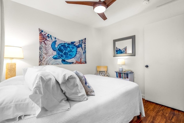 bedroom with ceiling fan and dark wood-type flooring