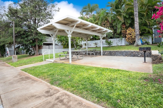 view of home's community featuring a yard and a patio