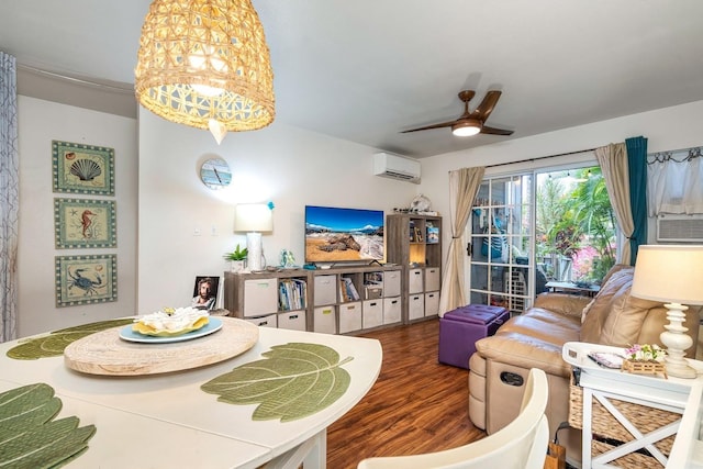 living room featuring a wall unit AC, ceiling fan with notable chandelier, and dark hardwood / wood-style floors