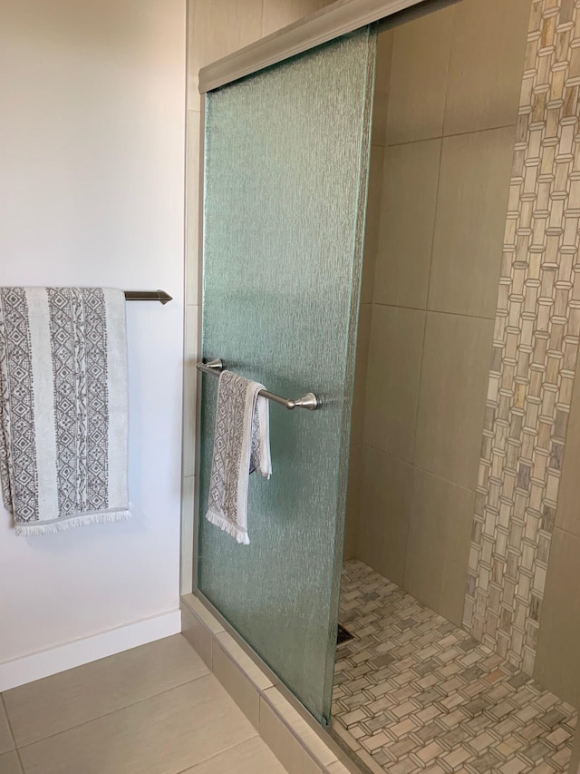 bathroom with tile patterned floors and walk in shower