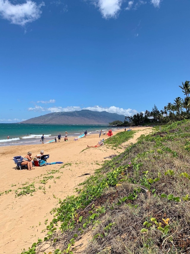 water view with a mountain view and a beach view