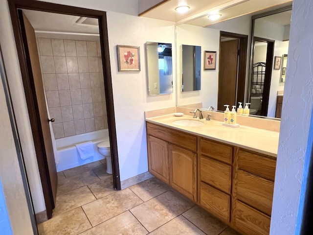 full bath with tile patterned flooring, toilet, vanity, and baseboards