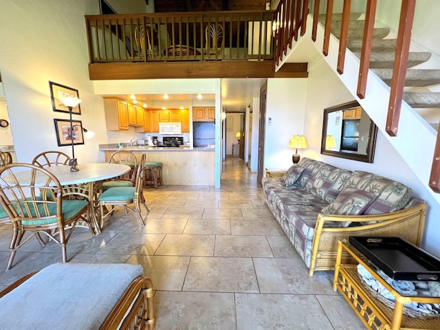 living room featuring stairs and a high ceiling