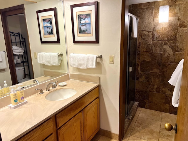 full bath with baseboards, vanity, and a shower stall