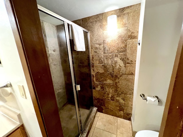 full bathroom with a shower stall and toilet