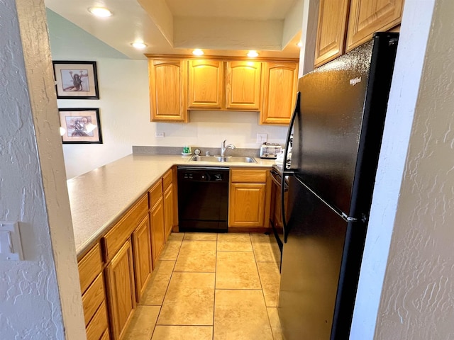 kitchen featuring light tile patterned floors, recessed lighting, a sink, black appliances, and light countertops