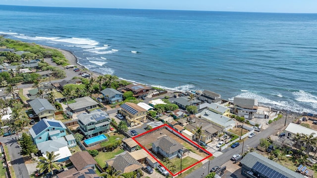 drone / aerial view with a residential view, a beach view, and a water view