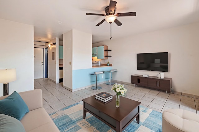 tiled living room with ceiling fan