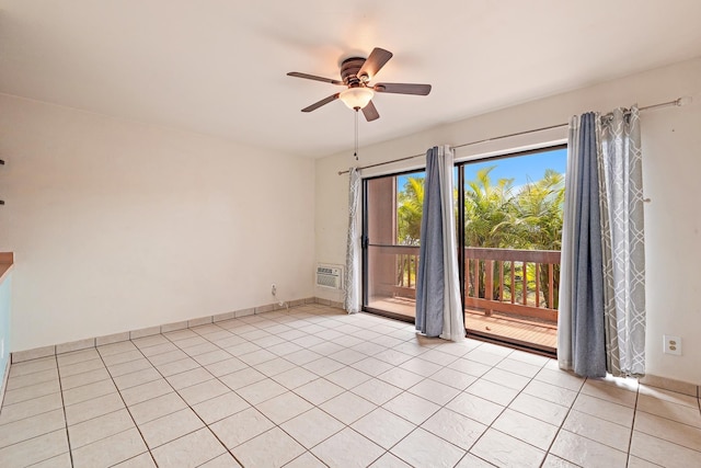 empty room featuring ceiling fan, light tile patterned floors, and a wall mounted air conditioner