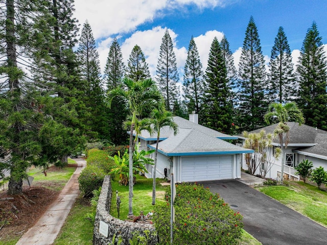 view of front of house with a front yard and a garage