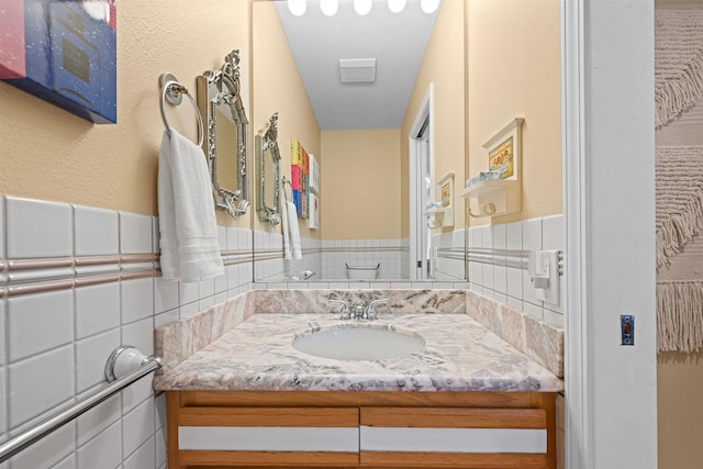 bathroom featuring vanity and decorative backsplash