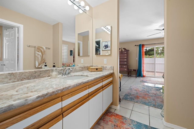 bathroom with tile patterned flooring, vanity, and ceiling fan