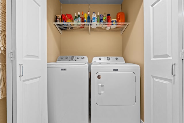 laundry room with washing machine and clothes dryer