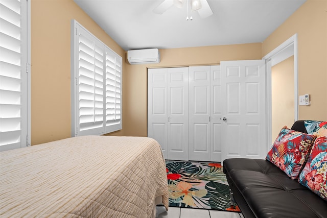 bedroom featuring ceiling fan, a wall unit AC, and a closet