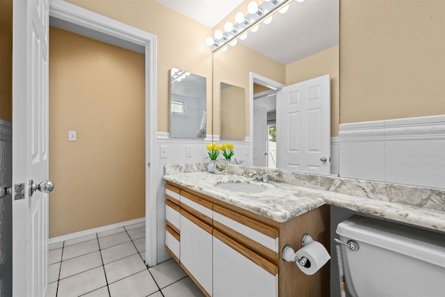 bathroom with vanity, tile patterned flooring, and toilet