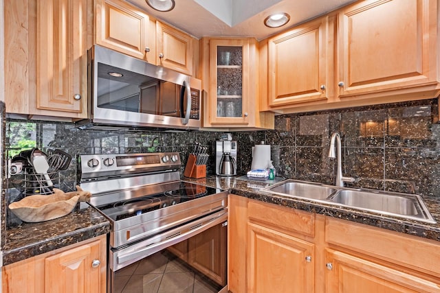 kitchen with stainless steel appliances, tile patterned flooring, sink, and backsplash