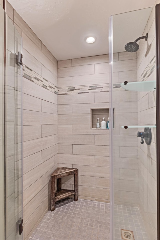 bathroom featuring a shower with door