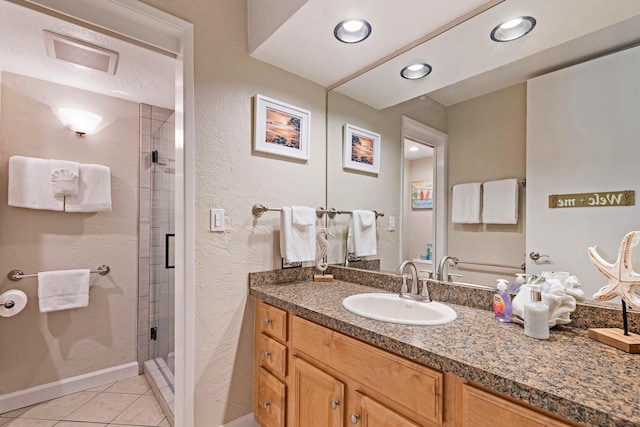 bathroom featuring vanity, tile patterned flooring, and a shower with door