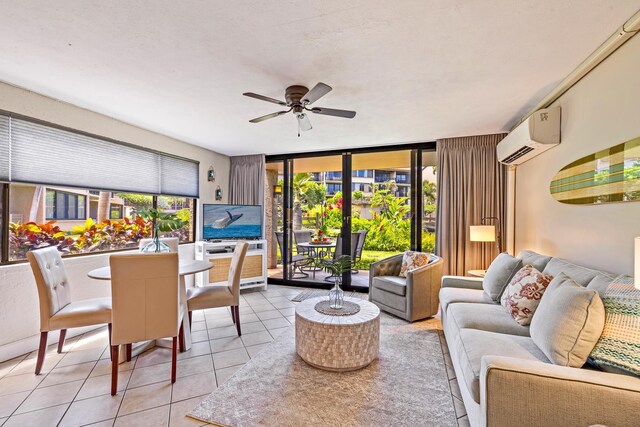 living room with a wall mounted air conditioner, light tile patterned floors, and ceiling fan