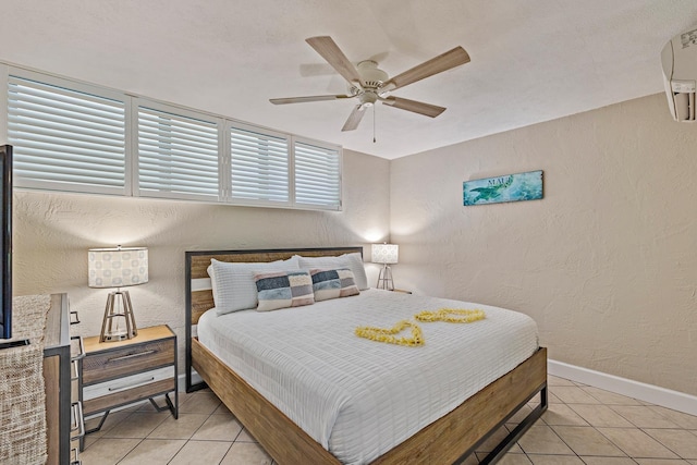 bedroom with ceiling fan, a wall mounted AC, and light tile patterned flooring