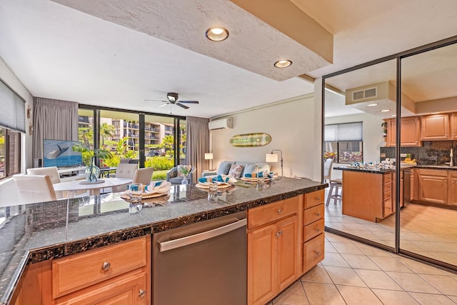 kitchen featuring light tile patterned floors, ceiling fan, decorative backsplash, stainless steel dishwasher, and an AC wall unit