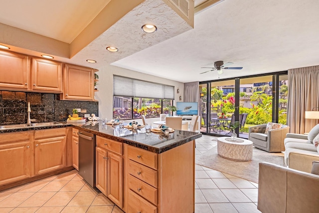 kitchen featuring tasteful backsplash, sink, light tile patterned floors, and kitchen peninsula