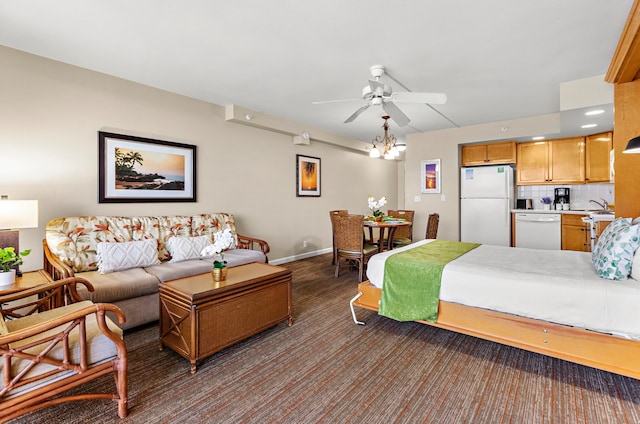 bedroom featuring white refrigerator, sink, and ceiling fan