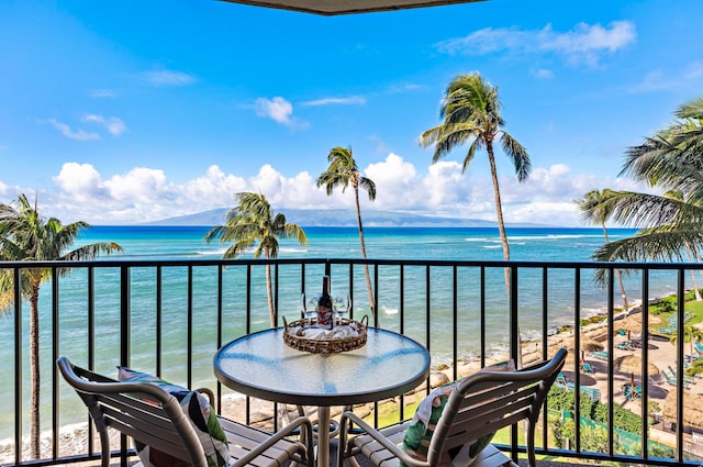 balcony with a view of the beach and a water view