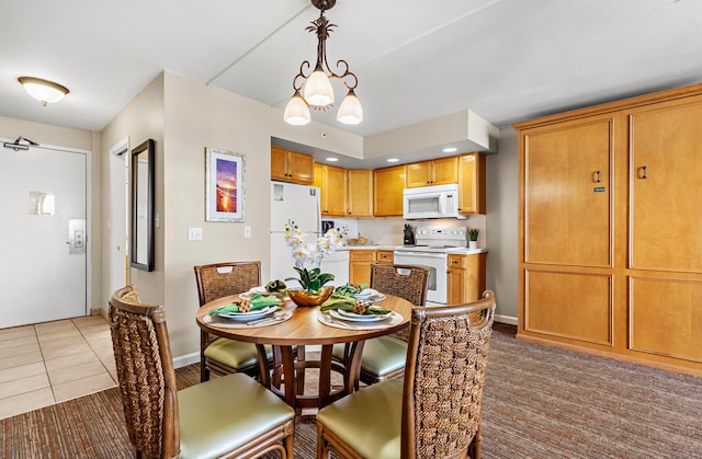 dining area with a notable chandelier and tile patterned floors