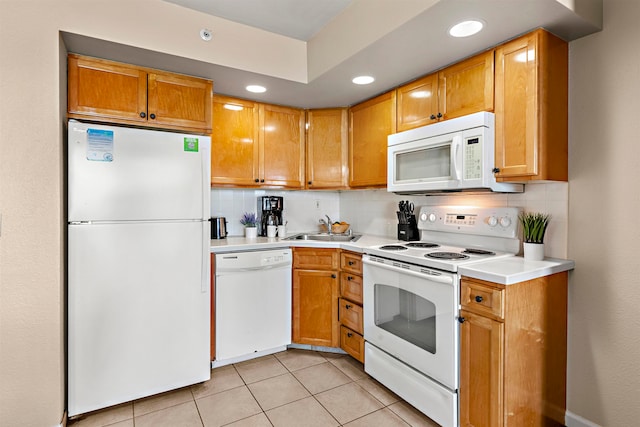 kitchen featuring decorative backsplash, sink, white appliances, and light tile patterned floors