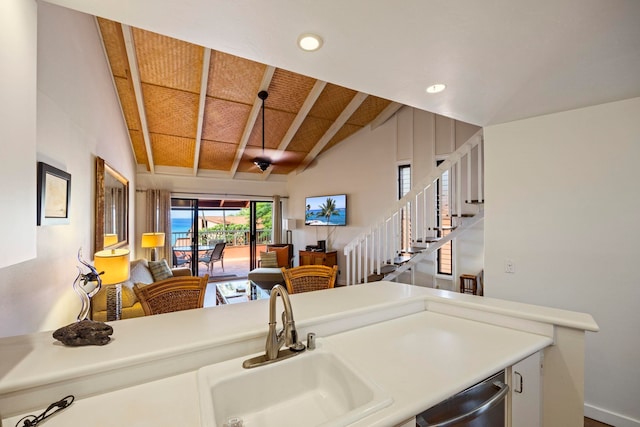 kitchen with wood ceiling, dishwasher, vaulted ceiling with beams, and sink