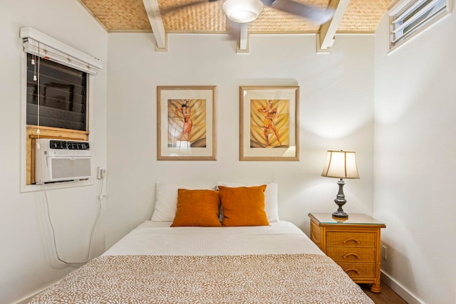 bedroom with ceiling fan, cooling unit, beam ceiling, and wood-type flooring